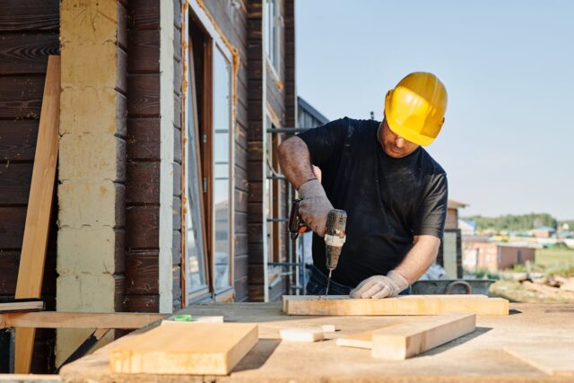 worker drilling wood
