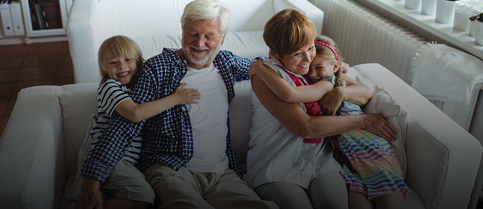 grandparents sitting with their grandchildren