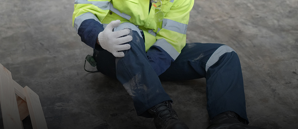 injured worker holding their knee